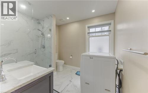 Walk-in shower with clear glass enclosure and stone-look wall tile - 104 Mausser Avenue, Kitchener, ON 
