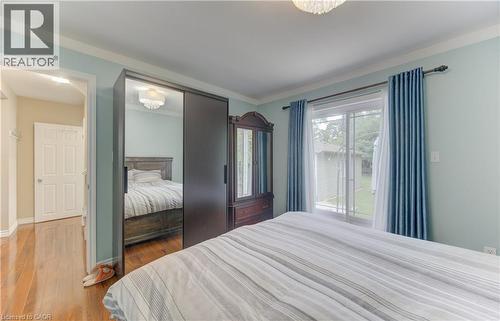 Hardwood flooring, sliding glass door, crown molding, ceiling-mounted light fixture, sliding mirrored closet doors - 104 Mausser Avenue, Kitchener, ON 