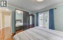 Hardwood flooring, sliding glass door, crown molding, ceiling-mounted light fixture, sliding mirrored closet doors - 