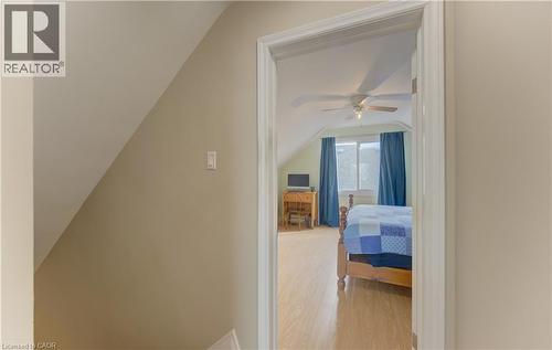Vaulted ceiling room with wood-finish flooring, a window with curtains, and a ceiling fan - 104 Mausser Avenue, Kitchener, ON 