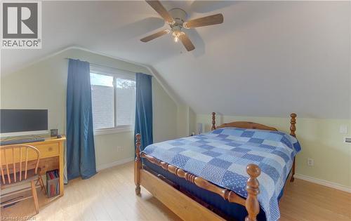 Angled ceiling lines with a ceiling fan, light wood-finish flooring, and a double window - 104 Mausser Avenue, Kitchener, ON 