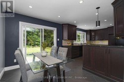 Dining area with walkout to backyard - 