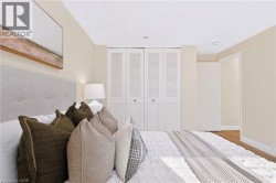 Hardwood-style flooring, louvered bi-fold closet doors, and recessed ceiling lighting - 