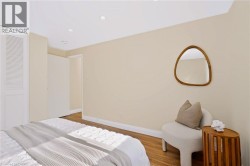 Recessed ceiling lighting, wood-finish flooring, and white baseboards - 