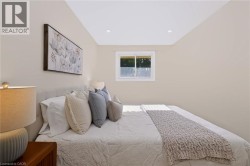 Recessed ceiling lighting, a single window, and light-toned wall finishes - 