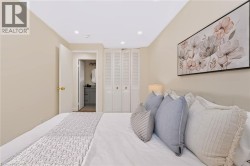 Recessed ceiling lighting, louvered bi-fold doors, and a neutral color palette - 