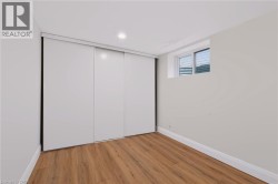 Recessed lighting, wood-finish flooring, white sliding closet doors, and white window trim - 