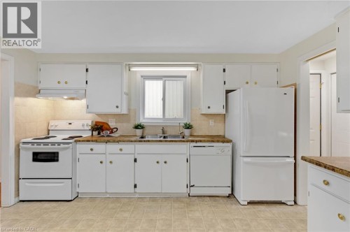 White cabinetry with gold-tone hardware, granite-look countertops, and tile flooring - 7 Underhill Crescent, Kitchener, ON 