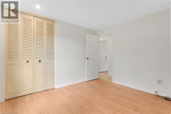 Wood-finish flooring throughout, paired with a louvered bifold closet door - 