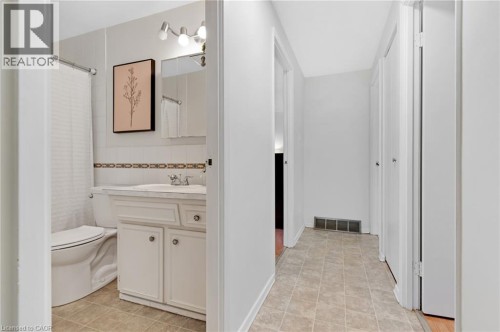 Bathroom featuring a white vanity with integrated sink, chrome faucet, and overhead track lighting - 7 Underhill Crescent, Kitchener, ON 