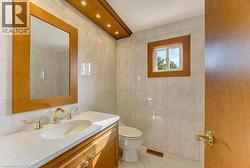 Wood-finish vanity with an integrated sink and gold-tone fixtures - 