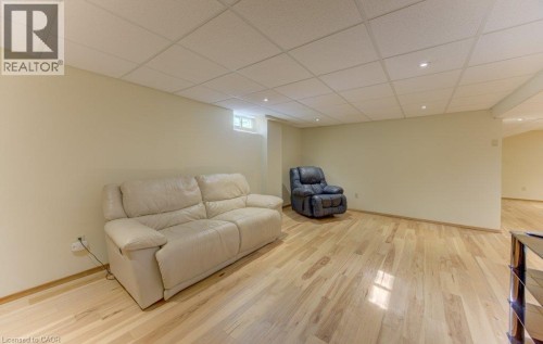 Spacious room featuring light wood-finish flooring, recessed lighting, and a drop ceiling - 238 Mcgarry Drive, Kitchener, ON 