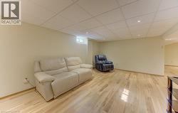 Spacious room featuring light wood-finish flooring, recessed lighting, and a drop ceiling - 