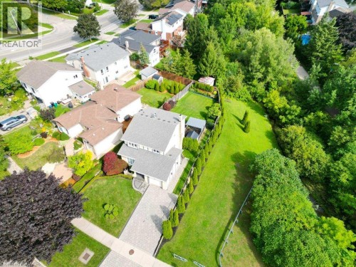 Two-story residence with a light gray facade, attached garage, and a paver driveway - 238 Mcgarry Drive, Kitchener, ON 