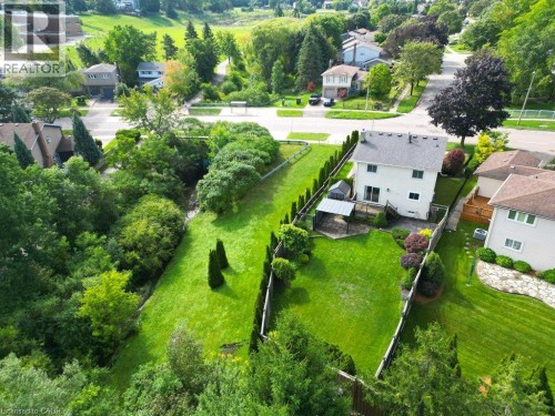 Expansive backyard featuring a manicured lawn, established landscaping, and a fenced perimeter - 238 Mcgarry Drive, Kitchener, ON 