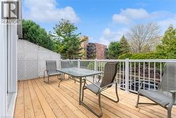 Wood-finish deck with white railings and a lattice privacy screen - 
