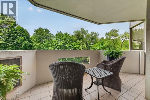 Outdoor balcony featuring light-toned tile flooring and a solid perimeter wall - 1237 North Shore Boulevard Unit# 405, Burlington, ON 