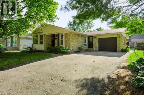 Stone veneer exterior with a covered entry, attached garage, and bay window - 95 Underhill Crescent, Kitchener, ON 