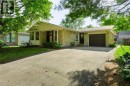 Stone veneer exterior with a covered entry, attached garage, and bay window - 95 Underhill Crescent, Kitchener, ON 