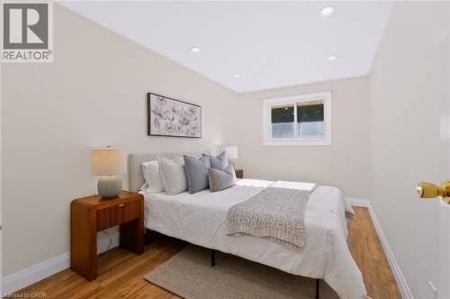 Recessed lighting, wood-finish flooring, white trim, and a window with a white frame - 95 Underhill Crescent, Kitchener, ON 