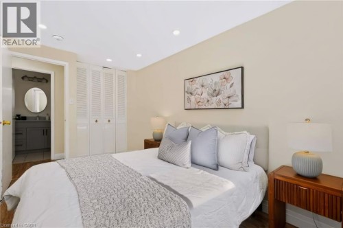 Recessed lighting, wood-finish flooring, louvered bi-fold closet doors, and light-toned wall paint - 95 Underhill Crescent, Kitchener, ON 