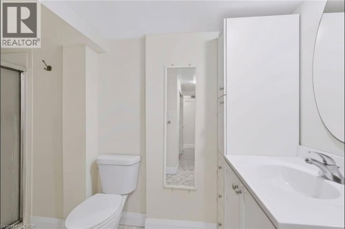 Vanity with an integrated sink, polished chrome faucet, and white cabinetry - 95 Underhill Crescent, Kitchener, ON 