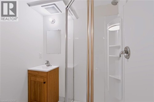 White vanity with wood-finish cabinet and integrated sink - 95 Underhill Crescent, Kitchener, ON 