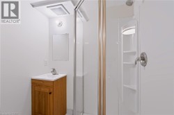White vanity with wood-finish cabinet and integrated sink - 