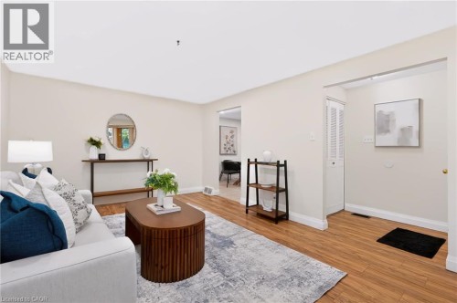 Light-toned walls, wood-finish flooring, and white trim create a bright atmosphere - 95 Underhill Crescent, Kitchener, ON 