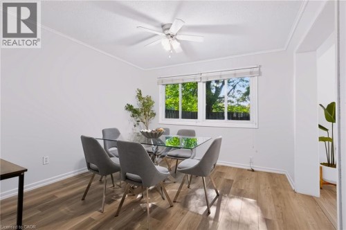Wood-finish flooring, white walls, white window trim, and a ceiling fan - 121 University Avenue E Unit# 102, Waterloo, ON 