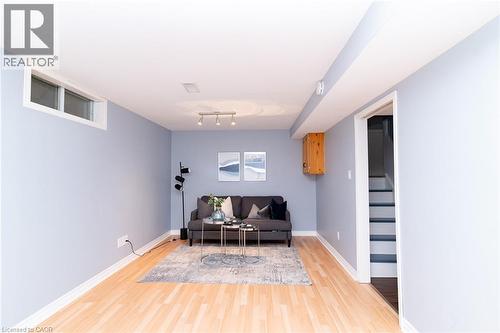 Recessed window, wood-finish flooring, track lighting, light blue wall paint, and a built-in wood cabinet - 543 Drummerhill Crescent, Waterloo, ON 