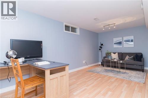 Light wood-finish flooring with crisp white trim - 543 Drummerhill Crescent, Waterloo, ON 