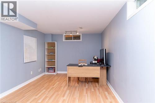 Wood-finish flooring with white trim, light blue walls, and a built-in window - 543 Drummerhill Crescent, Waterloo, ON 