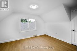 Bright upper-level bedroom with Vinyl floors - 