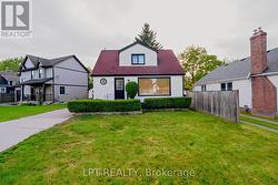 Charming front exterior with mature landscaping - 
