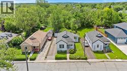 Aerial property perspective featuring three detached residences - 