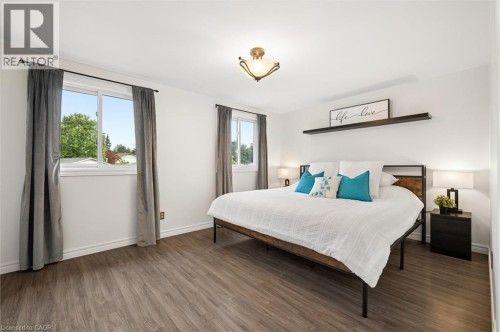Wood-finish flooring, white walls, and a ceiling-mounted light fixture - 76 Cluthe Crescent, Kitchener, ON 