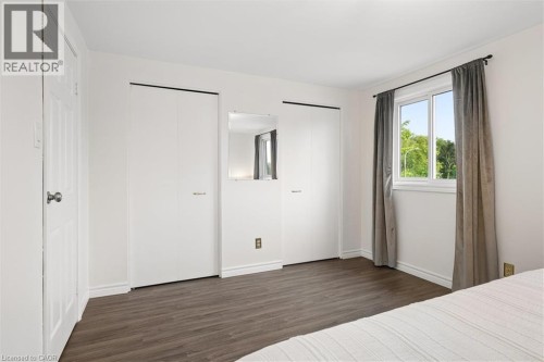 Wood-finish flooring with white baseboards - 76 Cluthe Crescent, Kitchener, ON 