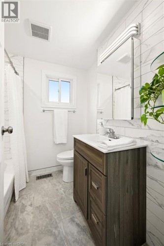 Modern vanity with a white countertop and chrome faucet - 76 Cluthe Crescent, Kitchener, ON 