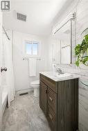 Modern vanity with a white countertop and chrome faucet - 