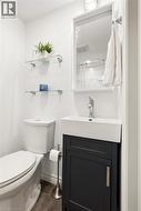 White vanity with a rectangular vessel sink, chrome faucet, and dark cabinet - 