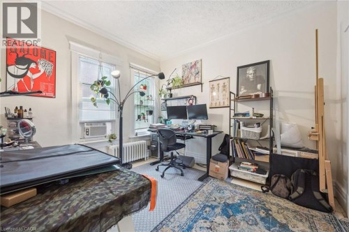 Room with two windows, crown molding, and a textured ceiling - 143 David Street, Kitchener, ON 