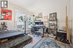 Room with two windows, crown molding, and a textured ceiling - 