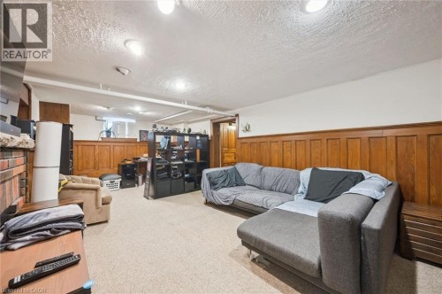 Carpeted flooring paired with wood paneling - 143 David Street, Kitchener, ON 