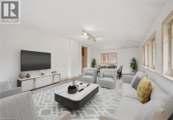 Bright interior space featuring a light-colored rug, multiple windows, and track lighting - 