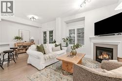 Living area featuring light wood-finish flooring and white walls - 