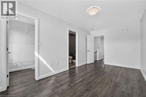 Wood-finish flooring, white walls, flush mount ceiling light, white trim, and built-in closet shelving - 1169 E Garner Road E Unit# 66, Ancaster, ON 
