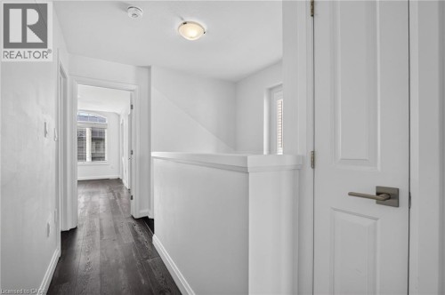Wood-finish flooring throughout the hallway - 1169 E Garner Road E Unit# 66, Ancaster, ON 