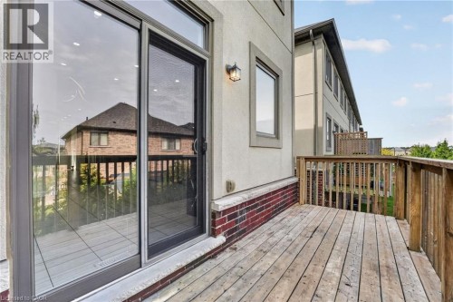 Wood deck with wooden railing - 1169 E Garner Road E Unit# 66, Ancaster, ON 