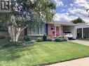 Red brick exterior with a dark roof and white trim - 3158 Palmer Drive, Burlington, ON 